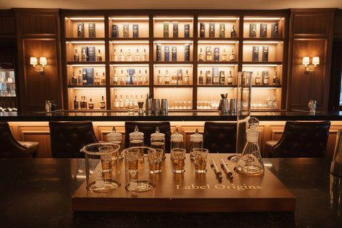 Bar setup with glasses and bottles in a dimly lit bar setting
