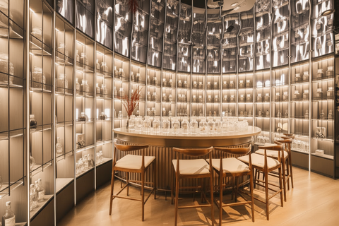 Round dining table with chairs in a modern bar setting with shelves in the background